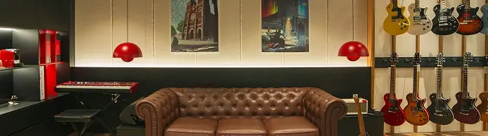 A couch and a display of guitars