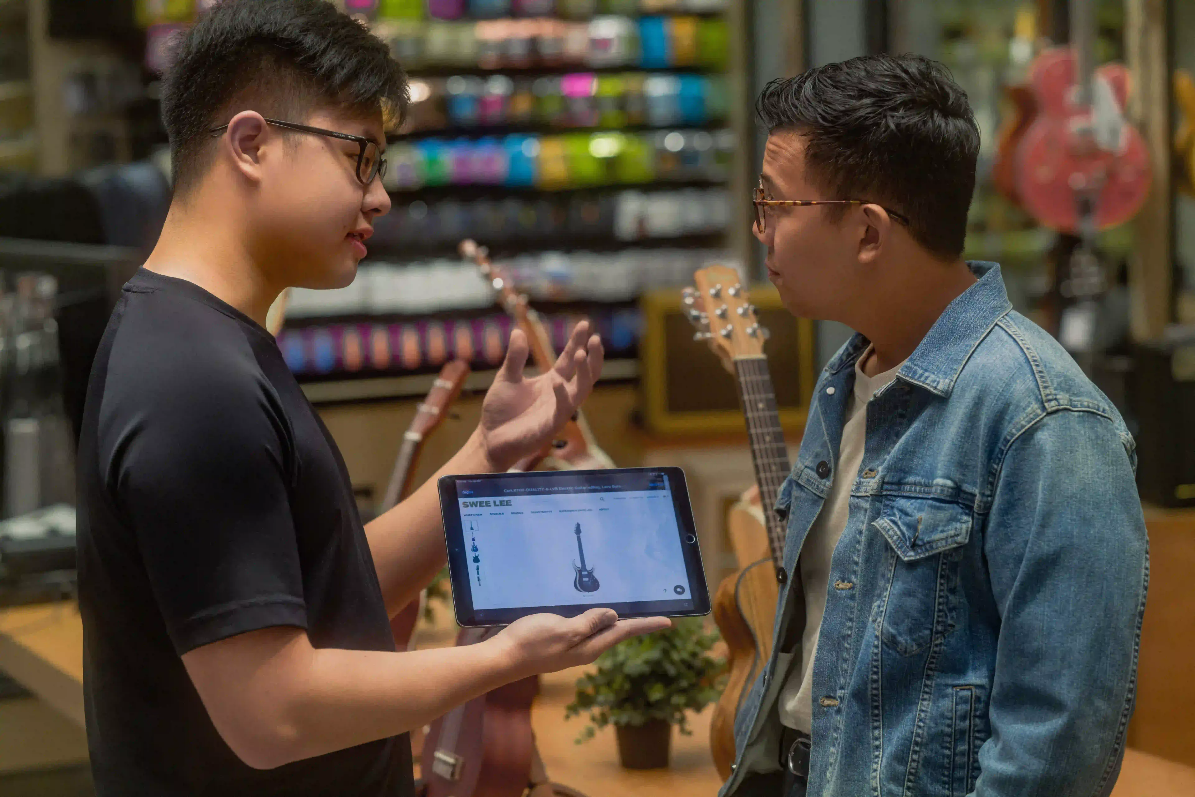 An employee helping a customer at Swee Lee Flagship Lot 10