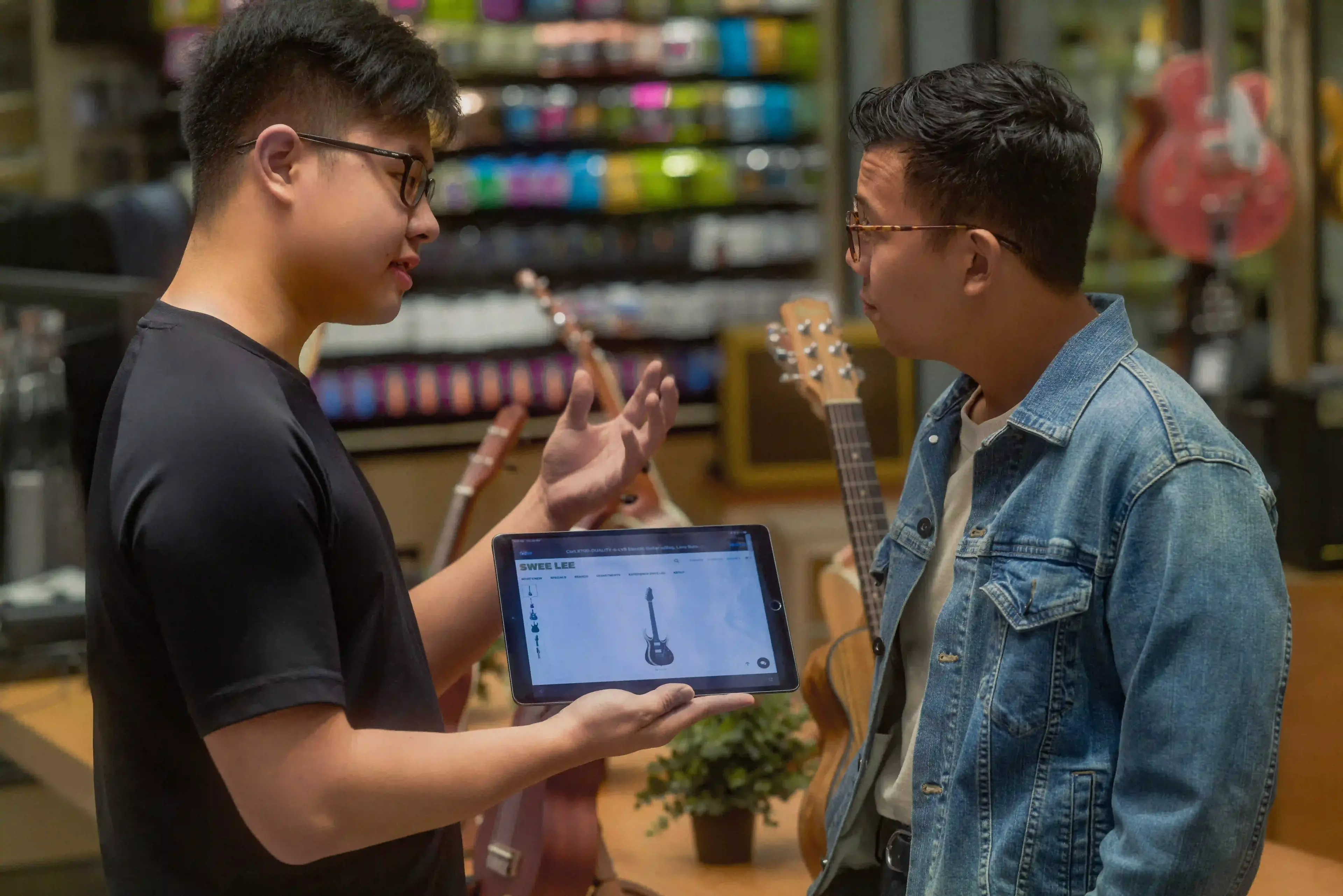 An employee helping a customer at Swee Lee Flagship Lot 10